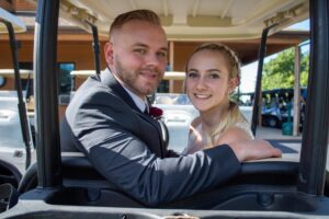 bride and groom on golf cart